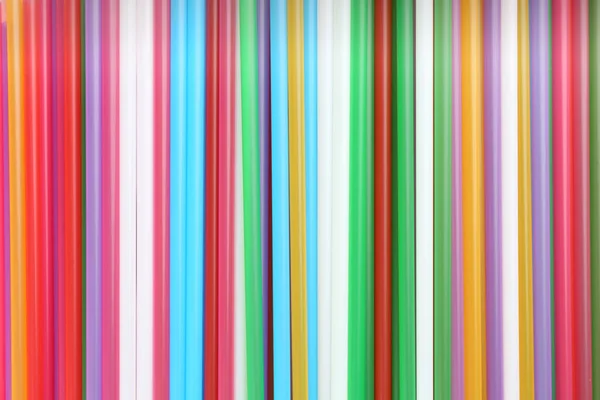 Heap of colorful plastic straws for drinks as background, closeup