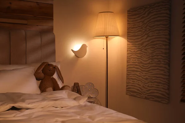 夜に子供部屋のベッドの近くで光るランプ — ストック写真