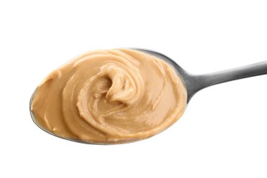 Beyaz kaşık içinde lezzetli fıstık ezmesi.