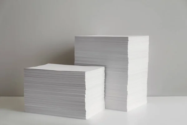 Stacks of paper sheets on white table