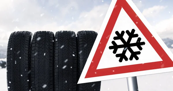 Set of winter tires and road sign outdoors
