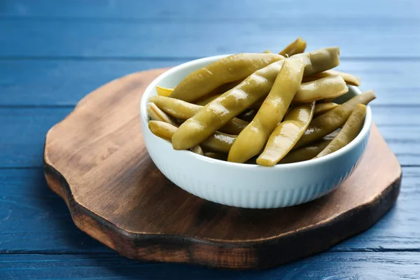 Canned green beans on blue wooden table