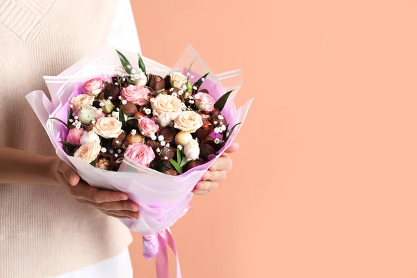 Woman with beautiful food bouquet on brown background, closeup. Space for text