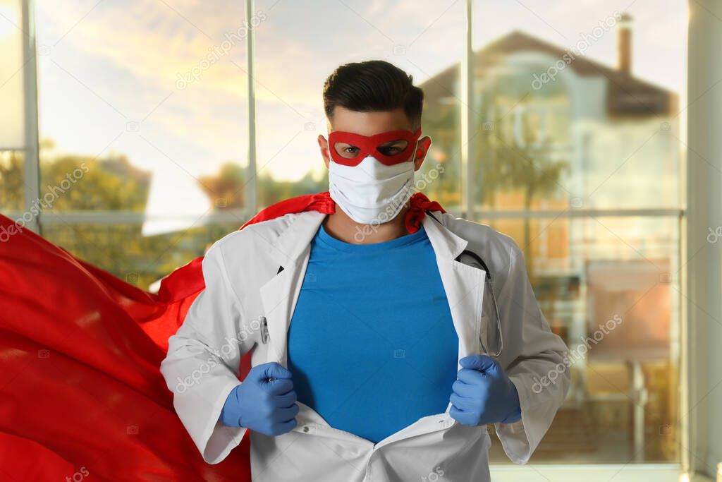 Doctor wearing face mask and cape indoors. Super hero power for medicine