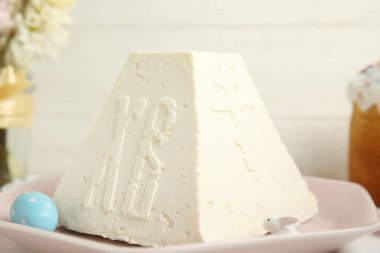 Traditional cottage cheese Easter paskha and egg on table, closeup