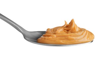 Beyaz kaşık içinde lezzetli fıstık ezmesi.