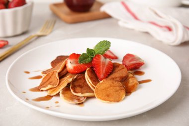 Cereal pancakes with strawberries on light grey marble table