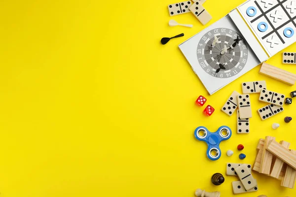 Different Types Board Games Its Components Yellow Background Flat Lay — Stock Photo, Image