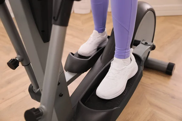 Woman Using Modern Elliptical Machine Indoors Closeup — Stock Photo, Image