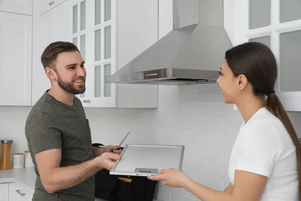 Woman Giving Filter Cooker Hood Man Kitchen — Stock Photo, Image