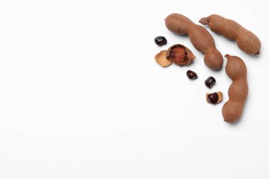 Olgun tamarindler beyaz arka planda, düz yerde. Metin için boşluk