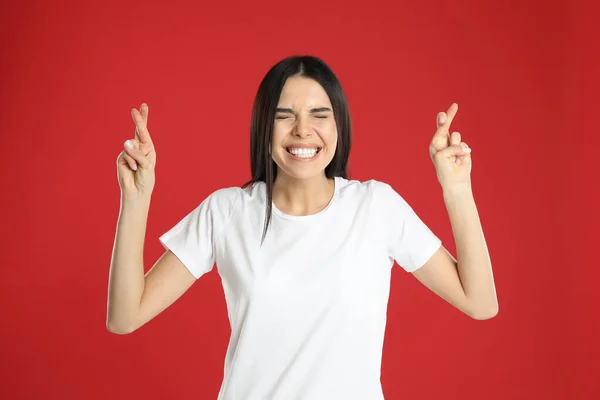 Mulher Com Dedos Cruzados Fundo Vermelho Conceito Superstição — Fotografia de Stock