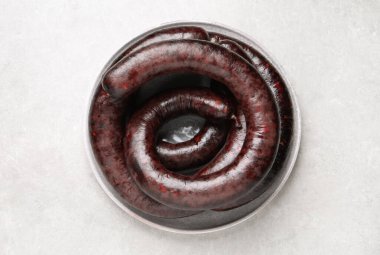 Açık gri masada leziz kanlı sosisler, üst manzara.