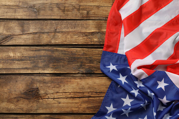 American flag on wooden table, top view with space for text. Memorial Day