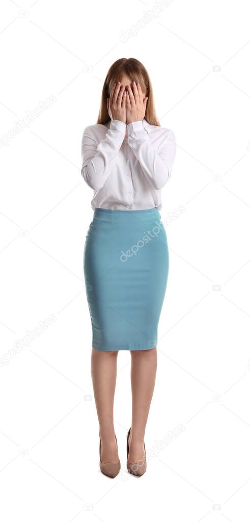 Upset woman closing her face with hands on white background