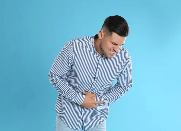 Man Suffering Stomach Ache Light Blue Background Food Poisoning — Stock Photo, Image