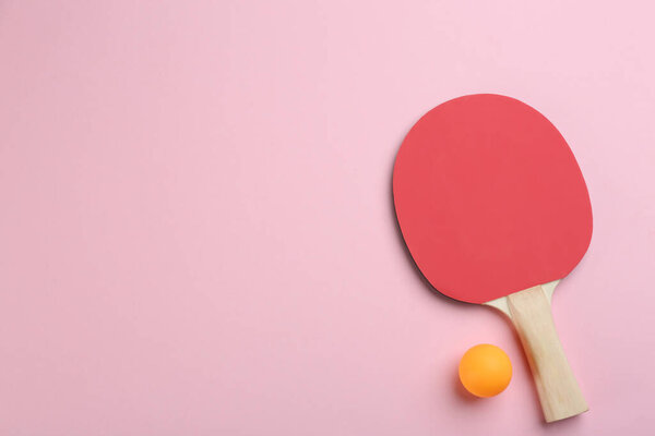 Ping pong racket and ball on pink background, flat lay. Space for text