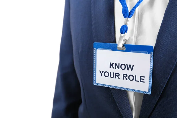 Office worker wearing badge with phrase Know Your Role, closeup. Corporate social responsibility