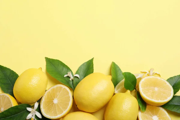 Many Fresh Ripe Lemons Green Leaves Flowers Yellow Background Flat — Stock Photo, Image
