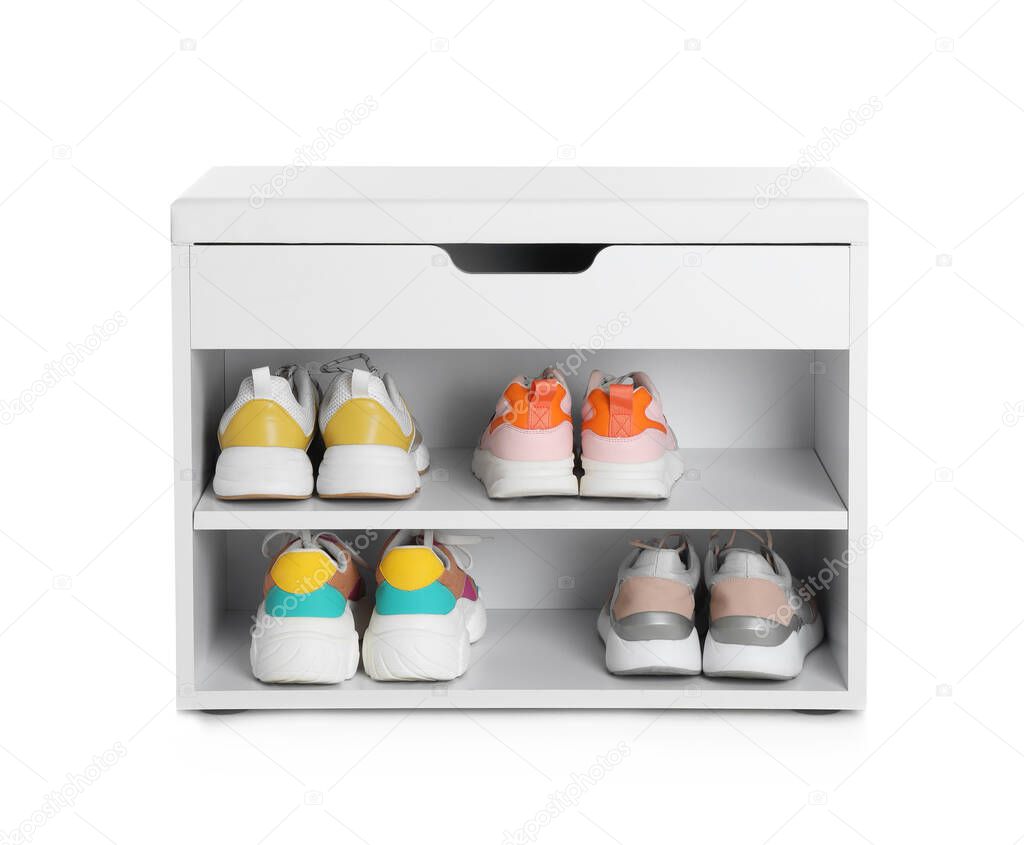 Stylish storage cabinet with different pairs of shoes on white background