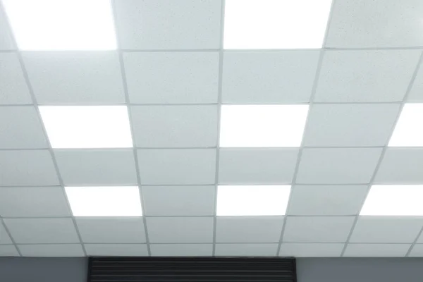 White ceiling with lighting in office room