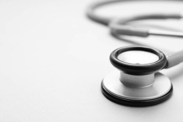 Stethoscope on white background, closeup. Space for text