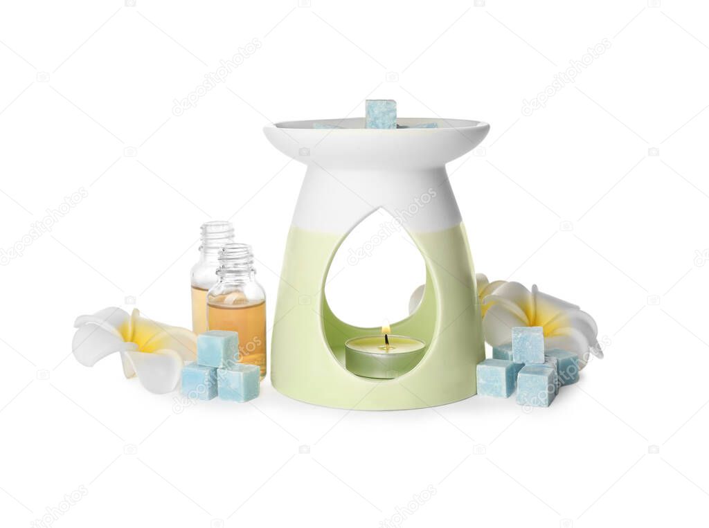 Stylish aroma lamp with essential wax cubes, oil and flowers on white background