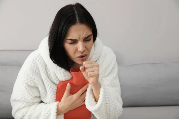 Ill Woman Hot Water Bottle Coughing Home — Stock Photo, Image