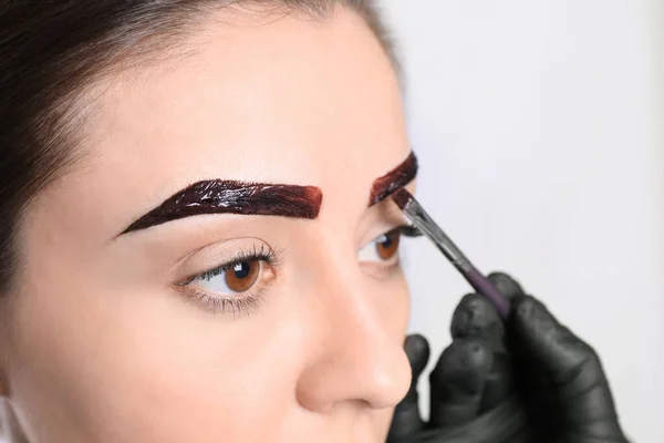 Beautician Applying Tint Eyebrows Correction Procedure Light Background Closeup — Stock Photo, Image