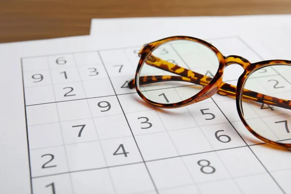 Sudoku Eyeglasses Wooden Table Closeup — Stock Photo, Image