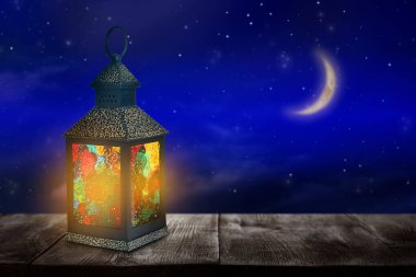 Geceleri ahşap masada güzel dekoratif Arap feneri, yazı için yer. Ramazan sembolü kadar fani