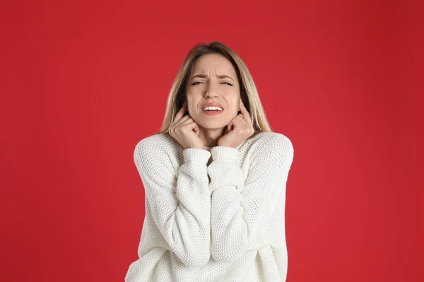 Emotional Young Woman Covering Her Ears Fingers Red Background — Stock Photo, Image