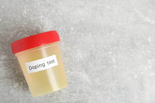 Açık Gri Taş Masa Üzerinde Doping Testi Yapılmış Bir Kavanoz — Stok fotoğraf