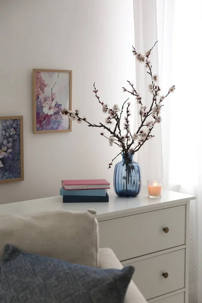 Flowering Tree Twigs Burning Candle Books White Chest Drawers Living — Stock Photo, Image