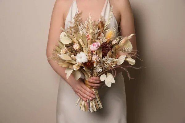 Bride Holding Beautiful Dried Flower Bouquet Beige Background Closeup — Stock Photo, Image