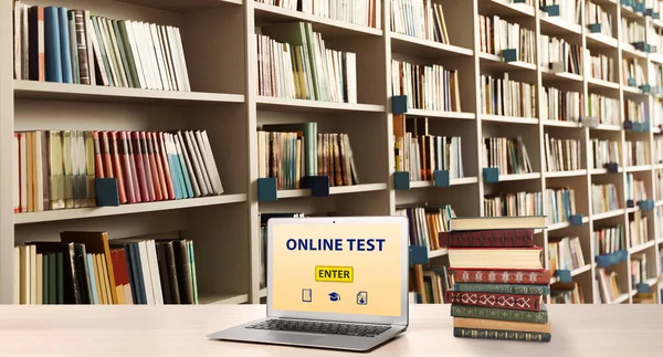 Laptop with online test on screen in library. Banner design