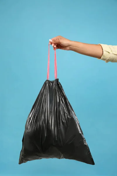 Woman Holding Full Garbage Bag Light Blue Background Closeup — Stock Photo, Image