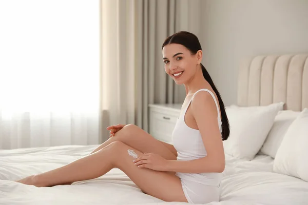 Young Woman Applying Body Cream Her Leg Home Space Text — Stock Photo, Image