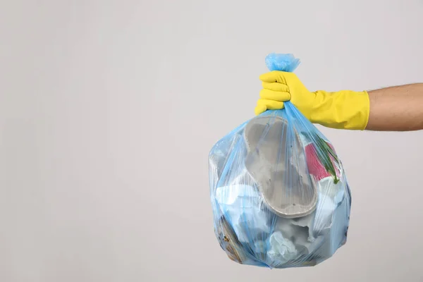 Man Holding Full Garbage Bag Light Background Closeup Space Text — Stock Photo, Image