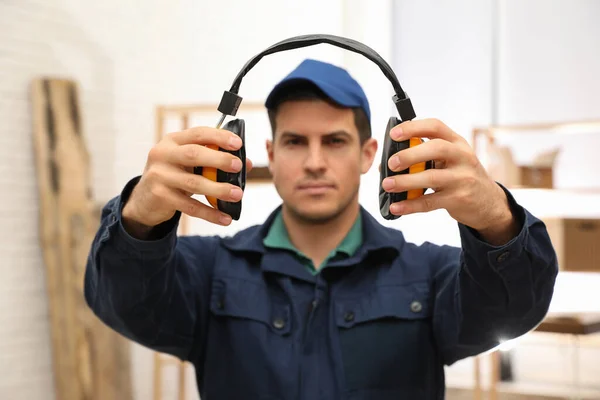 Worker Holding Safety Headphones Indoors Focus Hands Hearing Protection Device — Stock Photo, Image