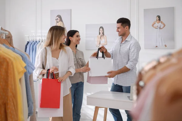 Modern Butikteki Müşterilere Giysi Dolu Çantalar Veren Bir Tezgahtar — Stok fotoğraf