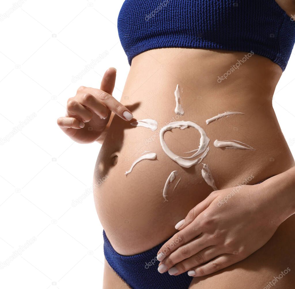Pregnant woman with sun protection cream on her belly against white background, closeup