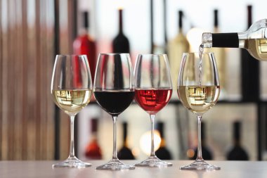 Beyaz şarabı şişeden bardağa dolduruyorum.