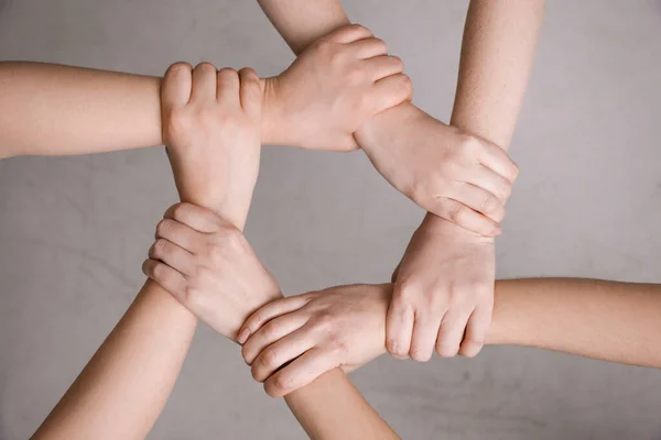 People Holding Hands Together Grey Background Top View Responsibility Concept — Stock Photo, Image