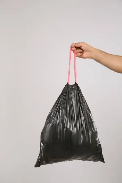 Man Holding Full Garbage Bag Light Background Closeup — Stock Photo, Image