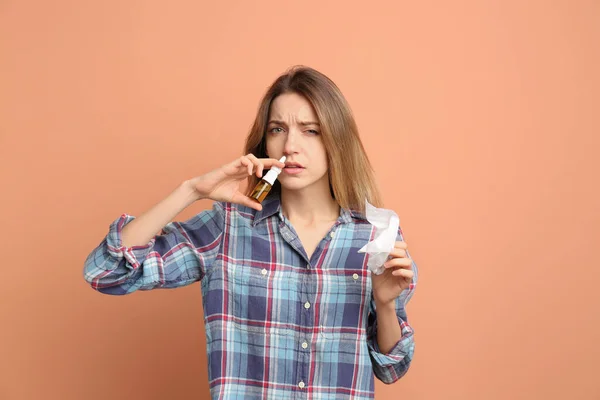 Sick Young Woman Using Nasal Spray Coral Background — Stock Photo, Image