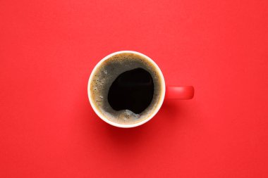 Kırmızı arka planda bir fincan aromatik kahve.