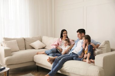 Mutlu aile oturma odasındaki rahat koltukta dinleniyor.