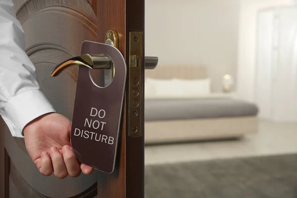 Man Putting Hanger Hotel Door Handle Indoors Closeup — Stock fotografie