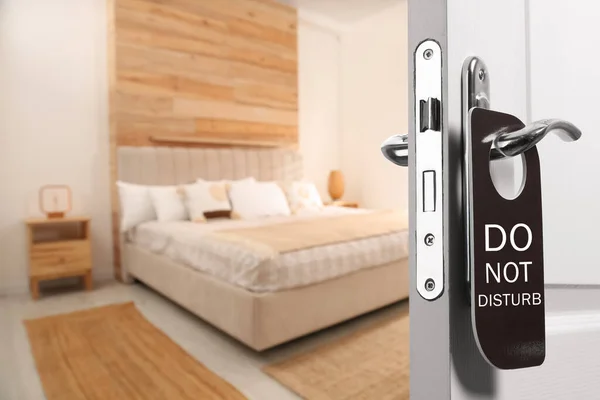 Wooden door open into modern hotel room, closeup